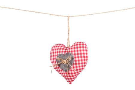 Checkered heart hanging a rope. Isolated on whiteの写真素材