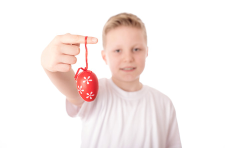 Young boy with his easter eggs over the white background