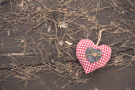 Photo of a heart shape on wooden backgroundの写真素材