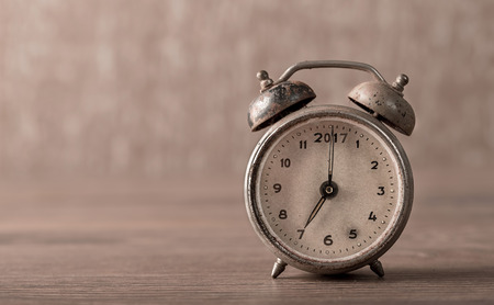 Vintage, old alarm clock on wooden background