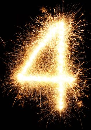 Sparkler firework light number 4 isolated on black backgroundの写真素材