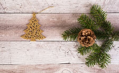 Pine branch and cone on a wooden background. Christmas decorationの写真素材