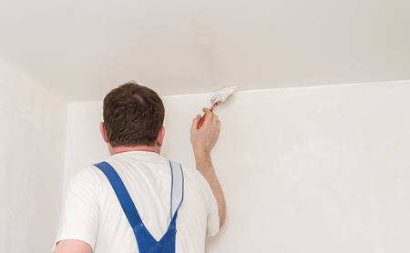 Painter work, with paintbrush. Restore the room. Back viewの写真素材