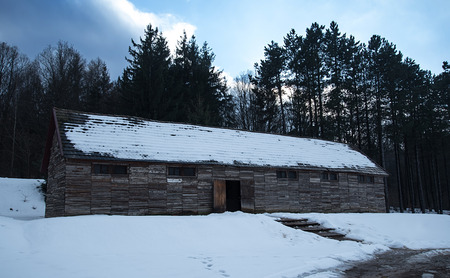 Old, wooden barrack in the forest a winters day