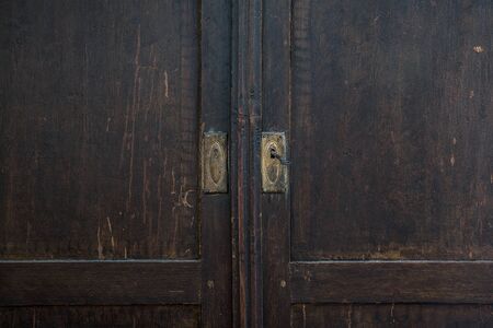 Closeup photo of old wardrobe door. Detailの写真素材