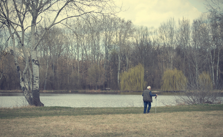 Old man walking in the park. Vintage viewの写真素材