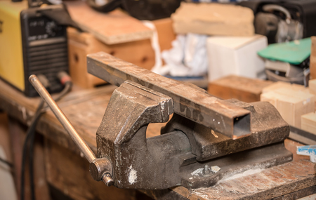 Metal workpiece in the vise. Closeup photo