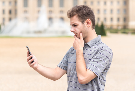 Handsome man use smart phone in the parkの写真素材