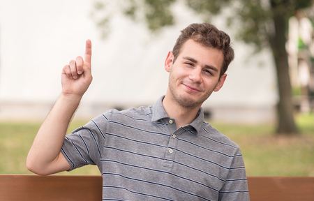Portrait of happy man pointing upの写真素材