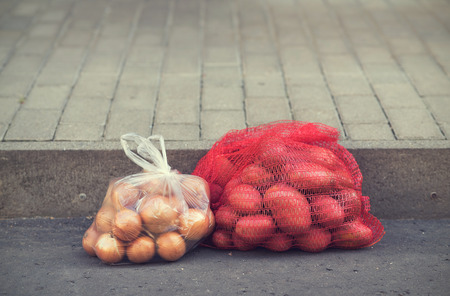 Bag of potatoes on the asphaltの写真素材