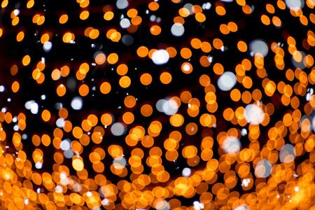 Blurred photo of bokeh background. Defocused glittering lights.
