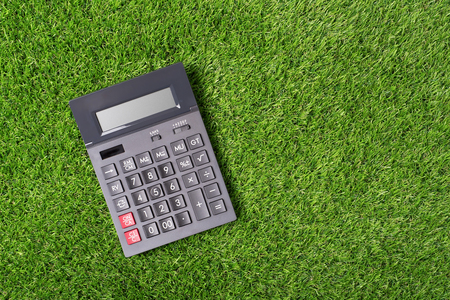 Calculator placed in green grass. Top of viewの写真素材