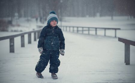 Young boy play in the winter parkの写真素材