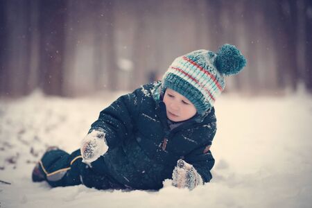 Young boy play in the snow a winters dayの写真素材