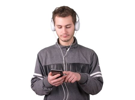 Handsome man searching music on his phone a white background