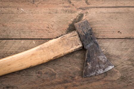 Old used axe on a wooden backgroundの写真素材
