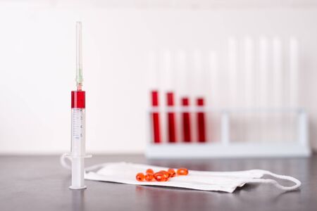 Blood sample in a syringe on the table in the laboratoryの写真素材