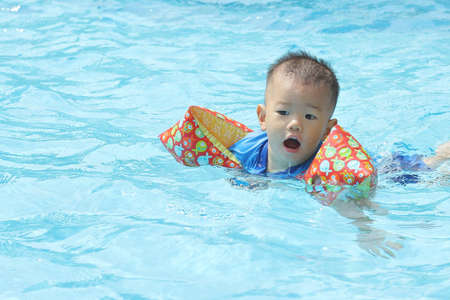 Oriental baby in poolの写真素材
