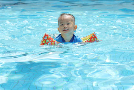Oriental baby in poolの写真素材