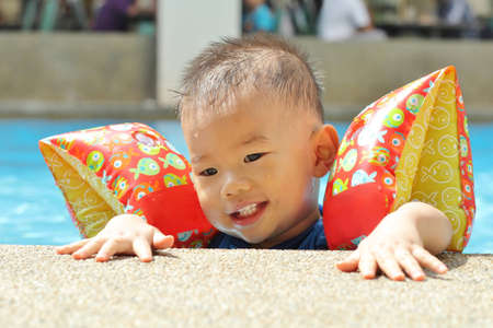 Asian baby in poolの写真素材