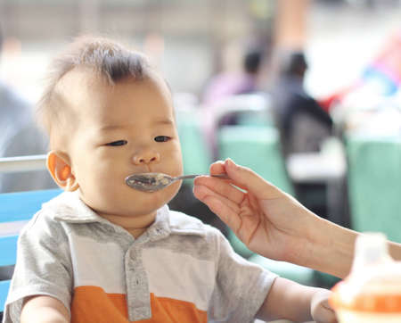 Asian baby eatingの写真素材