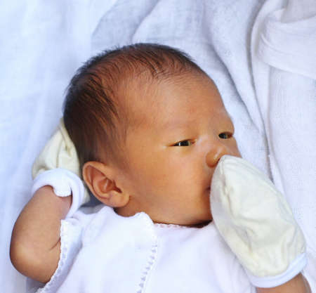 Asian baby awake on bedの写真素材