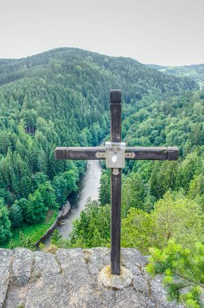 Cross on a rock above the river Ohre in Western Bohemiaの写真素材