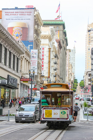 San Francisco, USA - October 4: San Francisco famous cable car running in the town with the boy hanging outside on October 4, 2011 in San Francisco, USA.のeditorial素材