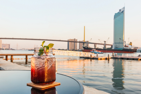 Blueberry soda with blurred Chaophraya river in background.の写真素材