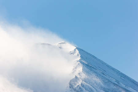 Peak of Fuji mountain with snow and cloud.の写真素材