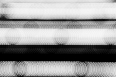 Row of white bokeh in the dark.の写真素材