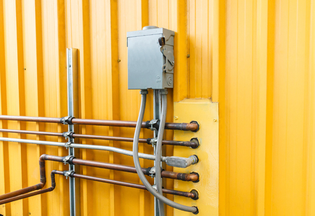 Electric safety switch with yellow background.
