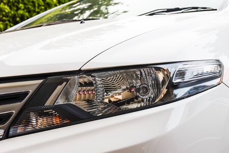 Beautiful head light of white car.