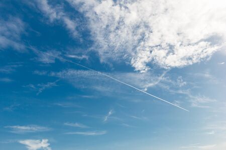Blue sky with cloud and contrail.