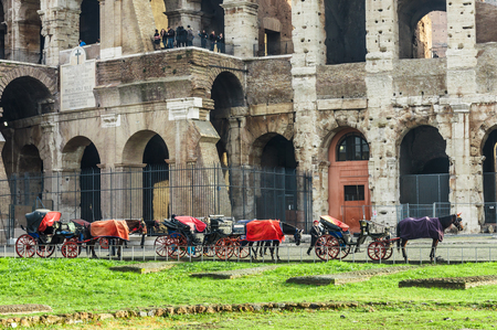 Rome, Italy - December 12, 2016: Famous landmark Colosseum in background and carriage in foreground.のeditorial素材
