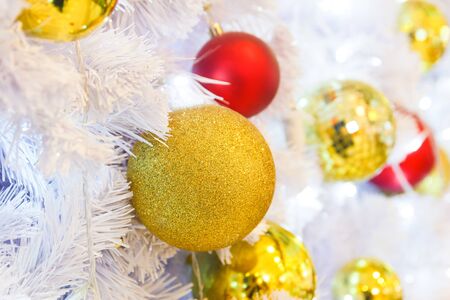 Golden ball decorate on white christmas tree.の写真素材