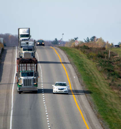 Truck transport on the highway, Magog, QuÃ©bec, Canada, October 27 2021のeditorial素材