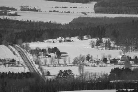 Road in a winter countryside landscape in the province of Quebec, Canada