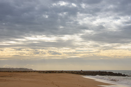 Beautiful sandy beach in Quarteira, Algarve, southern Portugal at the end of the dayの写真素材