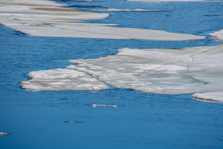 Melting ice in the spring on a lake in the Canadian forest in Quebec