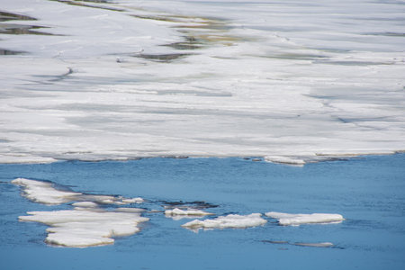 Melting ice in the spring on a lake in the Canadian forest in Quebecの写真素材