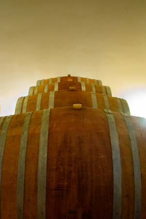 Large barrel of wine resting in a cellar in a large Italian wine estate.の写真素材