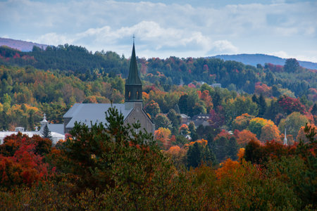 Village church through the colors of the Canadian fall in Quebecの写真素材