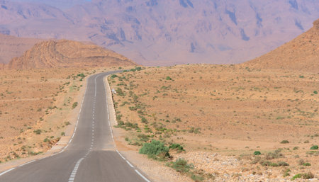 Long road through the Moroccan desert along the Atlas Mountainsの写真素材