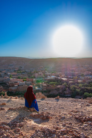 Woman observing the desert at Ait Ben Haddou in Moroccoの写真素材