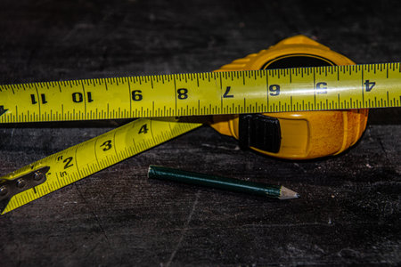 Tape measure on the workbench waiting to be used to build something useful