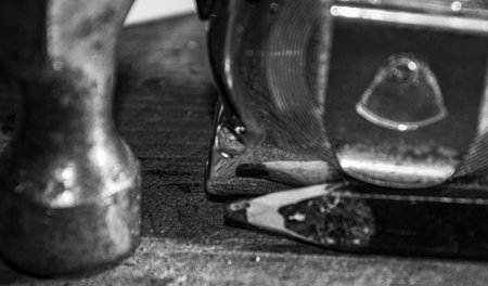 The hammer and tape measure forgotten on the workbench in the basement of the house