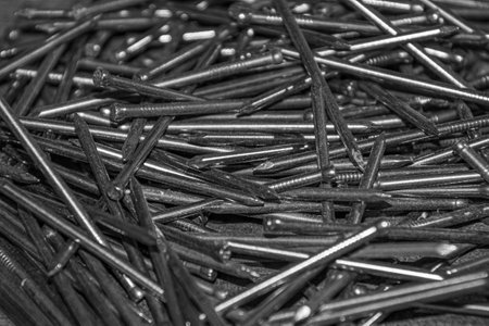 Pile of nails left on the workbench in the basement of the houseの写真素材