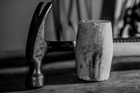 The hammer and mallet on the workbench in the basement of the houseの写真素材