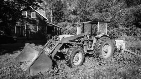 Old tractor on a farm in the Canadian countryside of Quebec